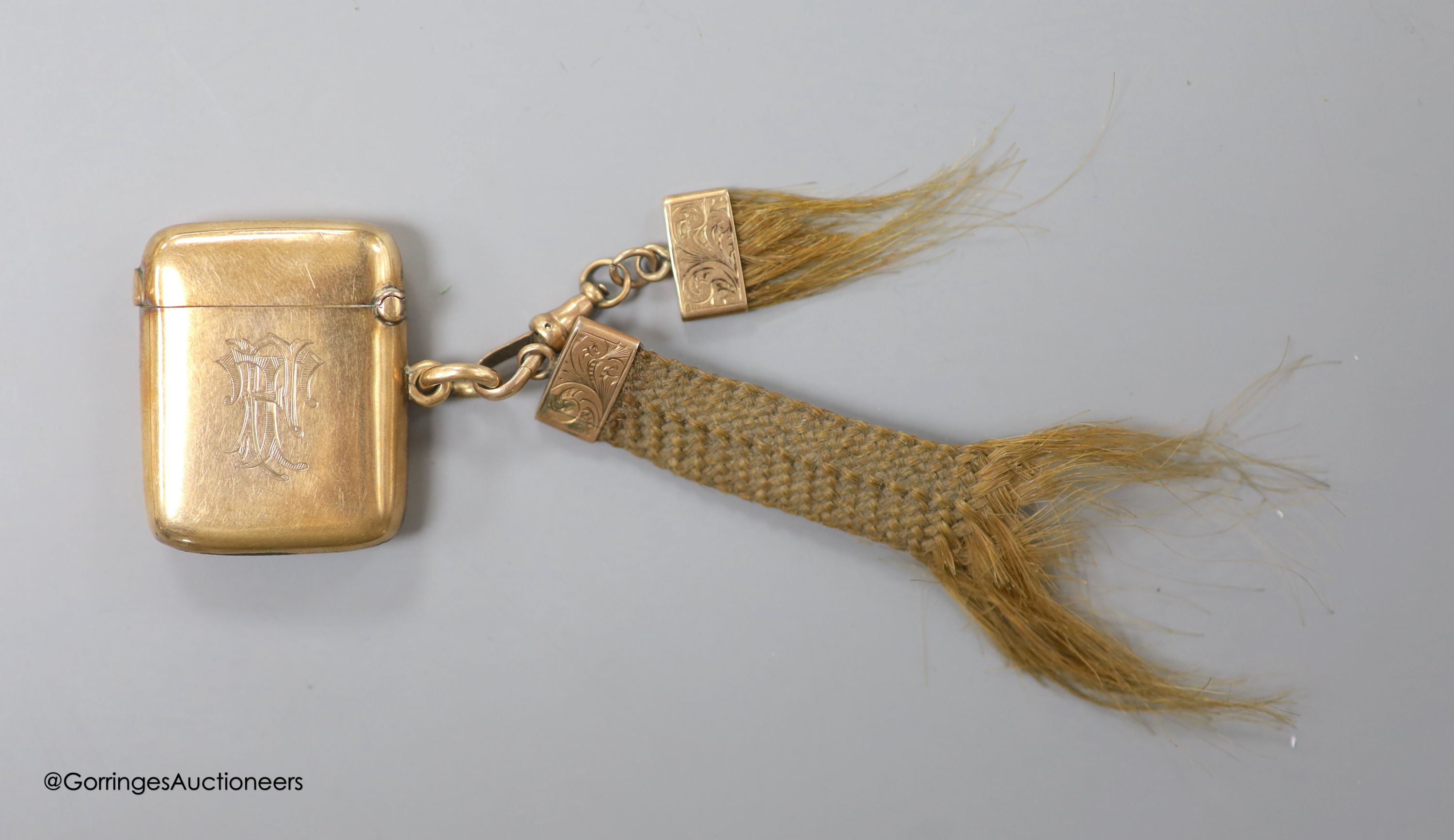 A late Victorian 9ct gold vesta case, William Neale, Chester, 1899, 40mm, with two hair mounted fobs